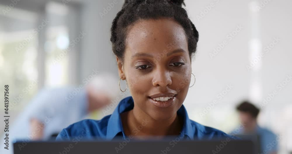 Young female employee looking at computer monitor during working day in office