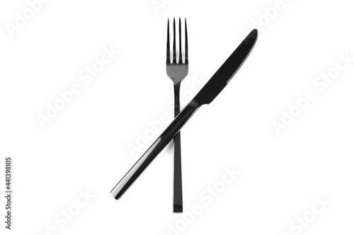 black cutlery knife and fork crossed on white background