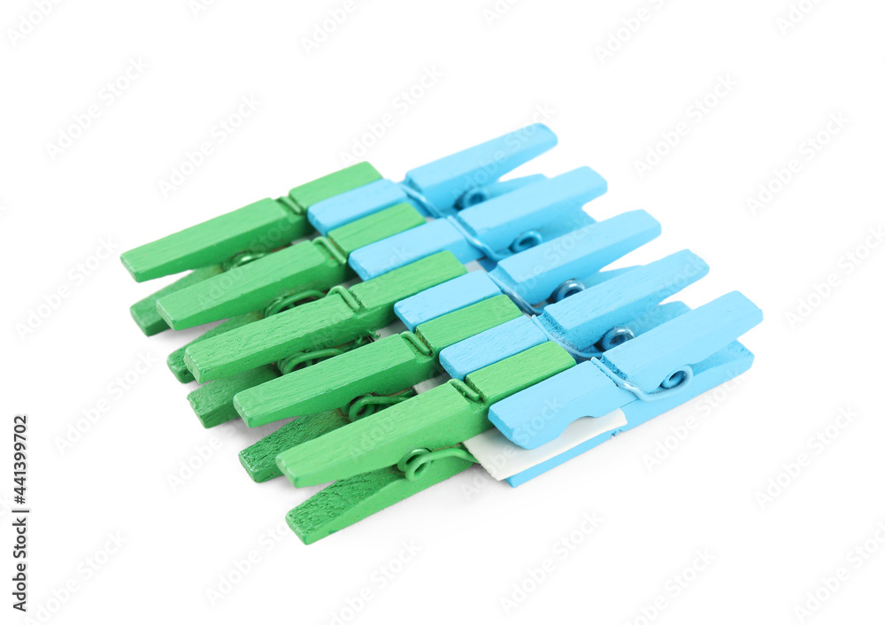 Set of colorful wooden clothespins on white background