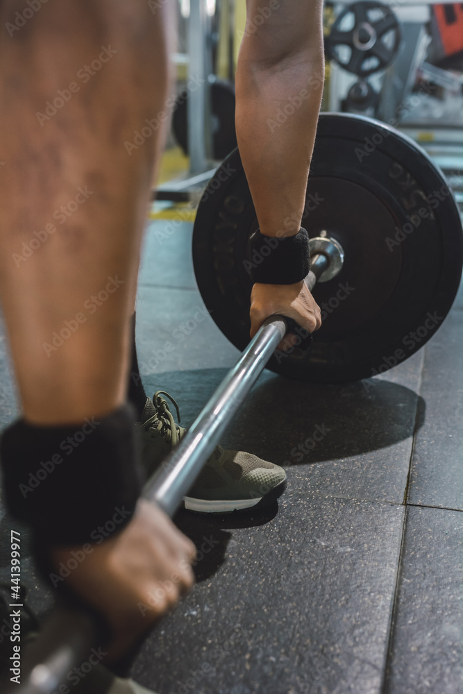 Anonymous man doing weightlifting exercise with barbell Anonymous man doing weightlifting exercise with barbell