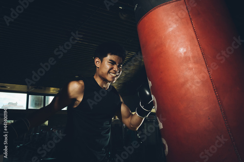 Asian male training boxing in the gym