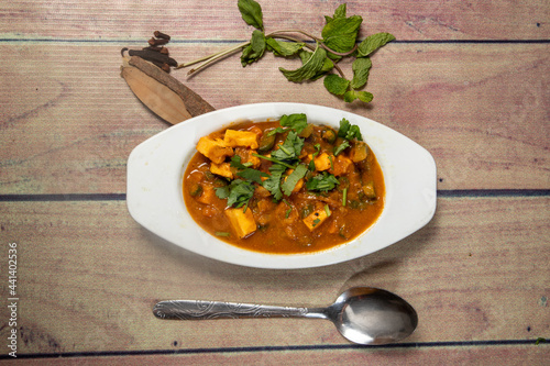 Aerial view of paneer gravy with coriander and spices