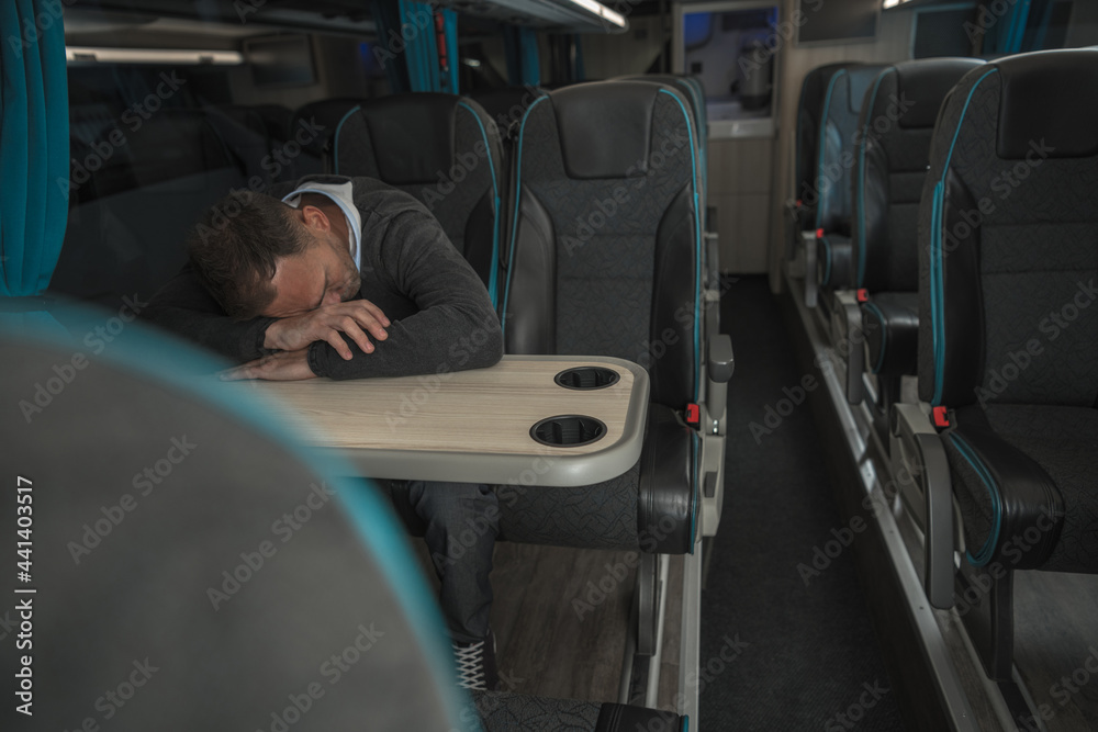 Tired Businessman Sleeping on Coach Bus Table Tired Businessman Sleeping on Coach Bus Table