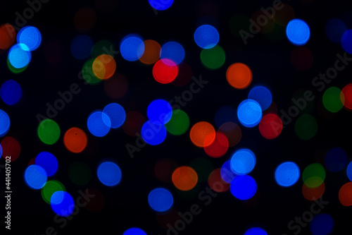 Multicolored bokeh on a black background. Abstract background