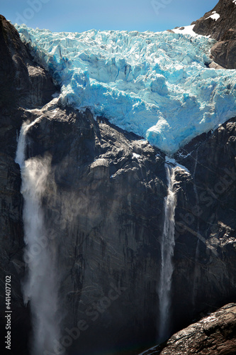 Queulat hanging snowdrift. Glacier in the mountain with waterfalls and melt river photo