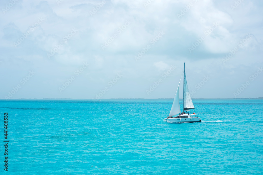 A luxury catamaran with some tourists sailing in the ocean of the Mexican Caribbean