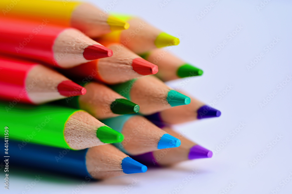 Close up of wooden pens with all colors of the rainbow against a white backround Close up of wooden pens with all colors of the rainbow against a white backround