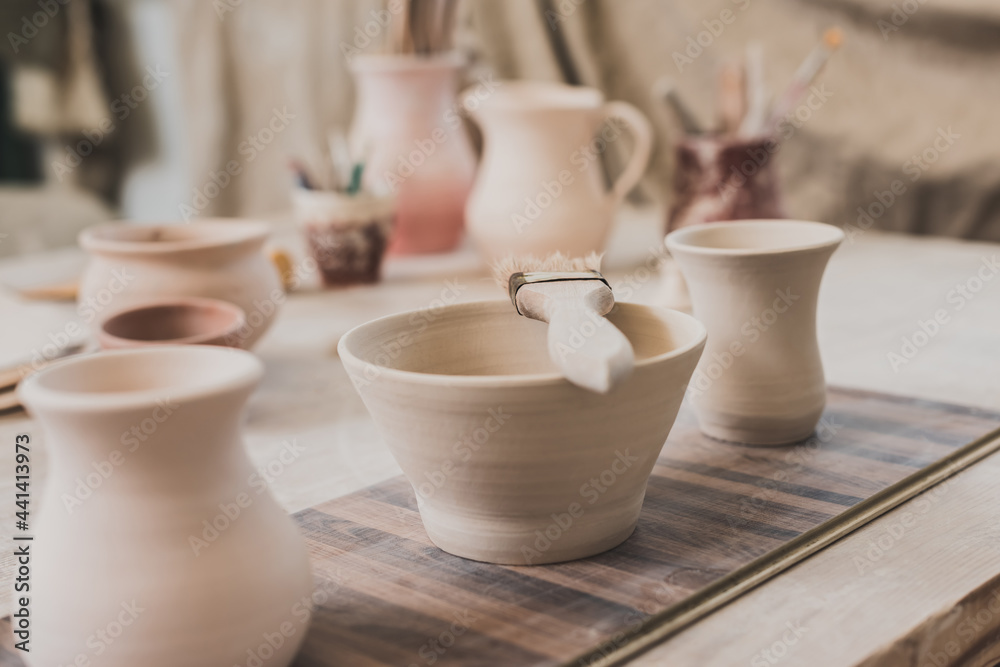 handmade clay bowls with brush on wooden table in pottery handmade clay bowls with brush on wooden table in pottery