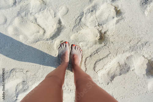 woman legs on sand beach