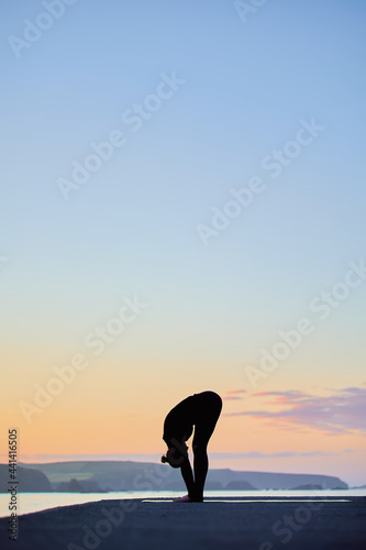 vertical image with large copy space of Caucasian woman practicing yoga