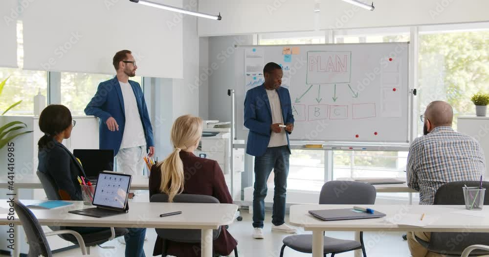 Diverse business partners presenting startup project to investors in modern office
