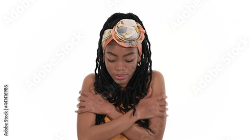 Portrait of a shivering African woman feeling cold. Isolated on a white background. photo