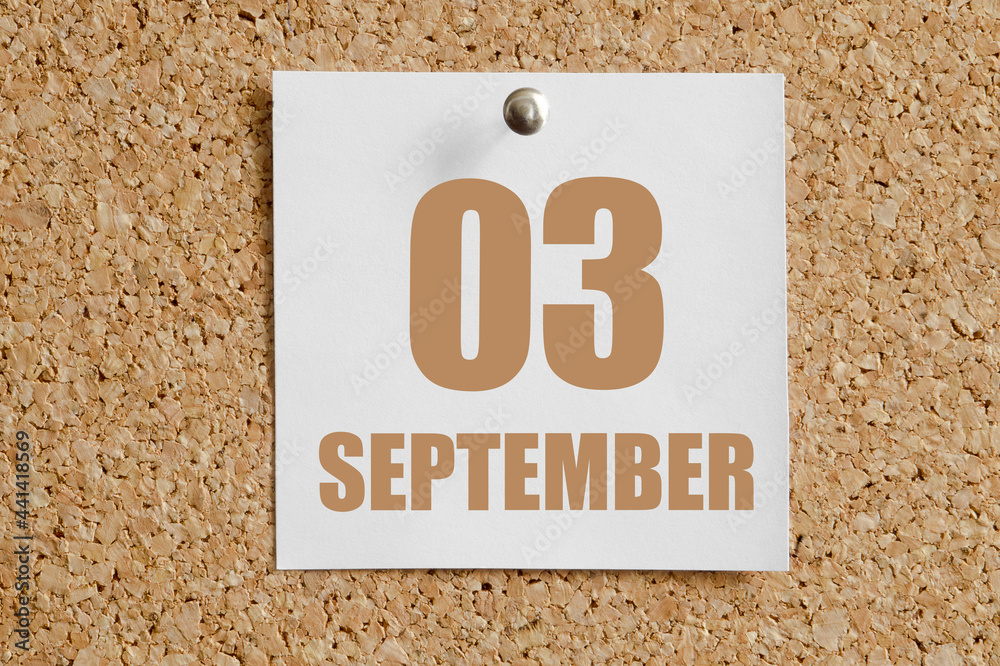september 03. 03th day of the month, calendar date.White calendar sheet attached to brown cork board.Autumn month, day of the year concept september 03. 03th day of the month, calendar date.White calendar sheet attached to brown cork board.Autumn month, day of the year concept