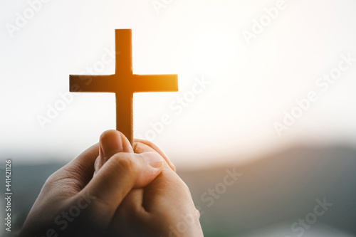 Fototapeta Naklejka Na Ścianę i Meble -  man hands palm up praying and worship of cross with Belief in Jesus Christ. Eucharist therapy god blesses help, hope, and faith, Christian religion concept on sunset background.