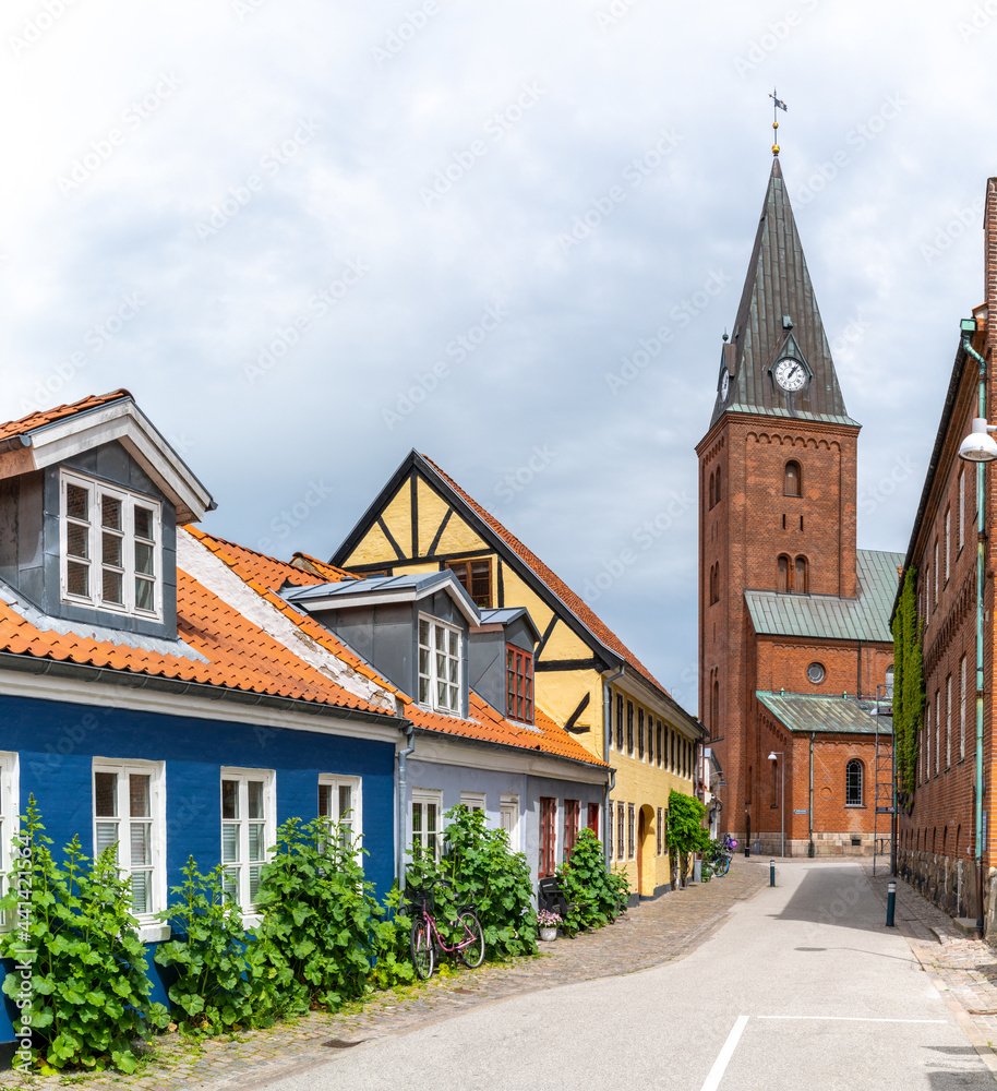 Obraz premium neighborhood street in historic Aalborg city center with colorful houses and the Church of Our Lady in the background