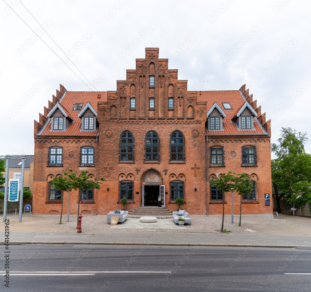 historic red brick building in the city center of Aalborg in northern Denmark