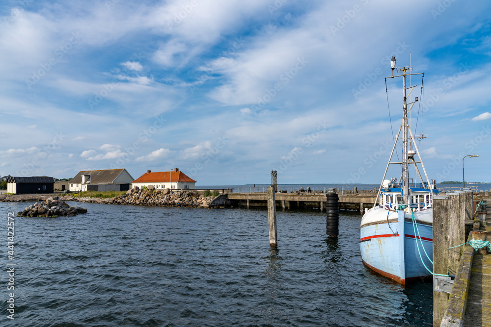 old fishing boat and docks in the industrial harbor and port of Kalvehave