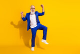 Full length body size photo of bearded senior man in stylish outfit gesturing like winner isolated on vivid yellow color background