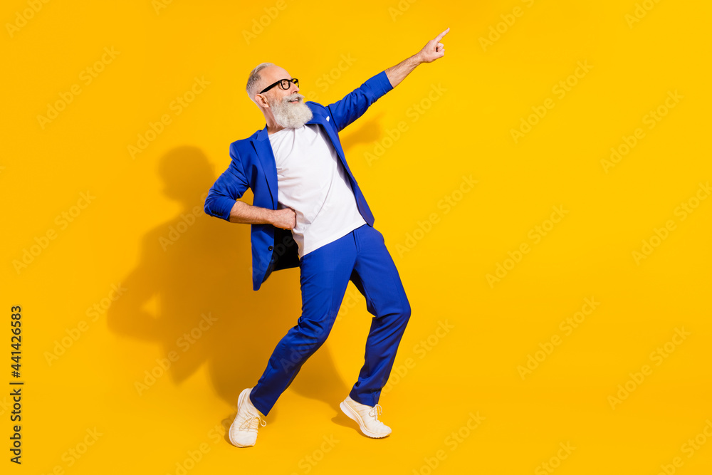 Full size profile photo of funny grey beard aged man dance wear spectacles blue jacket isolated on yellow background Full size profile photo of funny grey beard aged man dance wear spectacles blue jacket isolated on yellow background