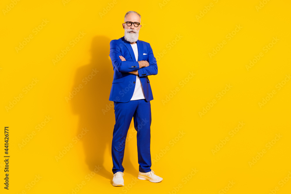 Full length body size view of attractive chic serious man folded arms isolated over bright yellow color background