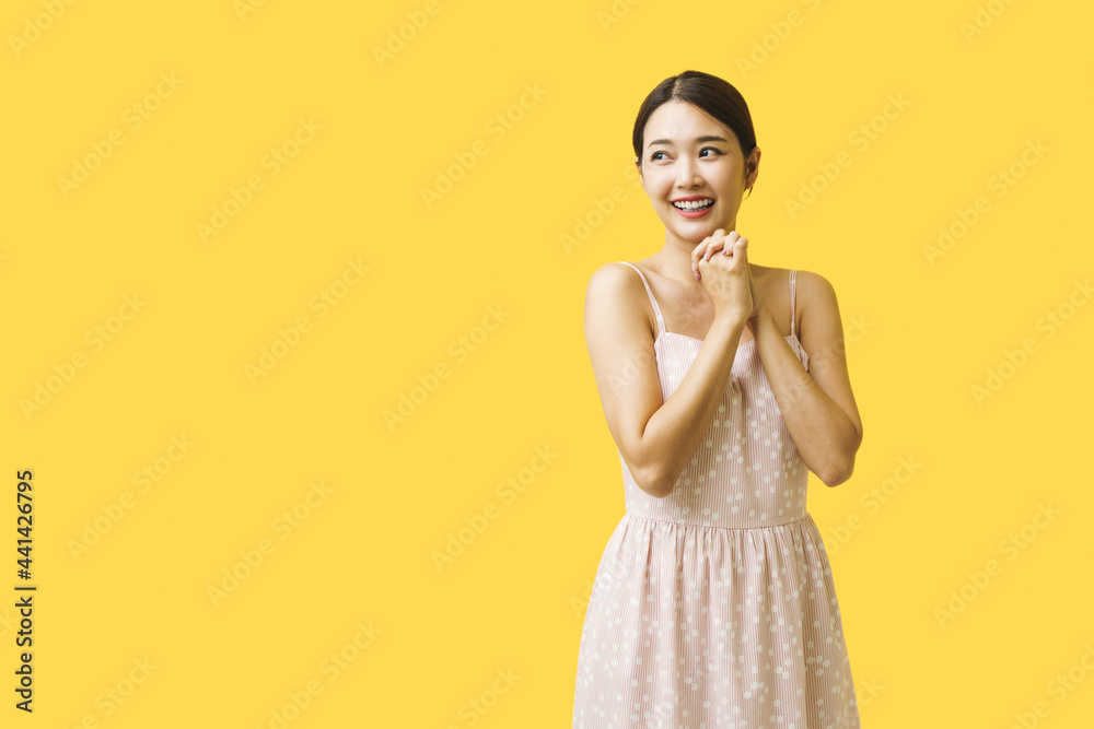 Asian beautiful woman posing and smiling over isolated yellow background. Asian beautiful woman posing and smiling over isolated yellow background.