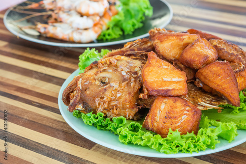 Fried fish with vegetable on dish. Local food in Thailand. Regional Food Backgrounds