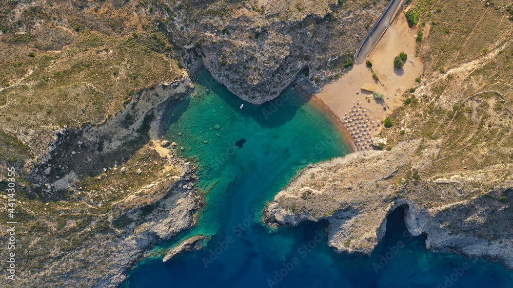 Aerial drone top down photo of heart shaped bay forming a lovers cove with emerald crystal clear sandy beach