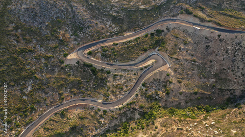 Aerial drone top down photo of serpentine winding asphalt road forming an "S" in uphill Mediterranean destination