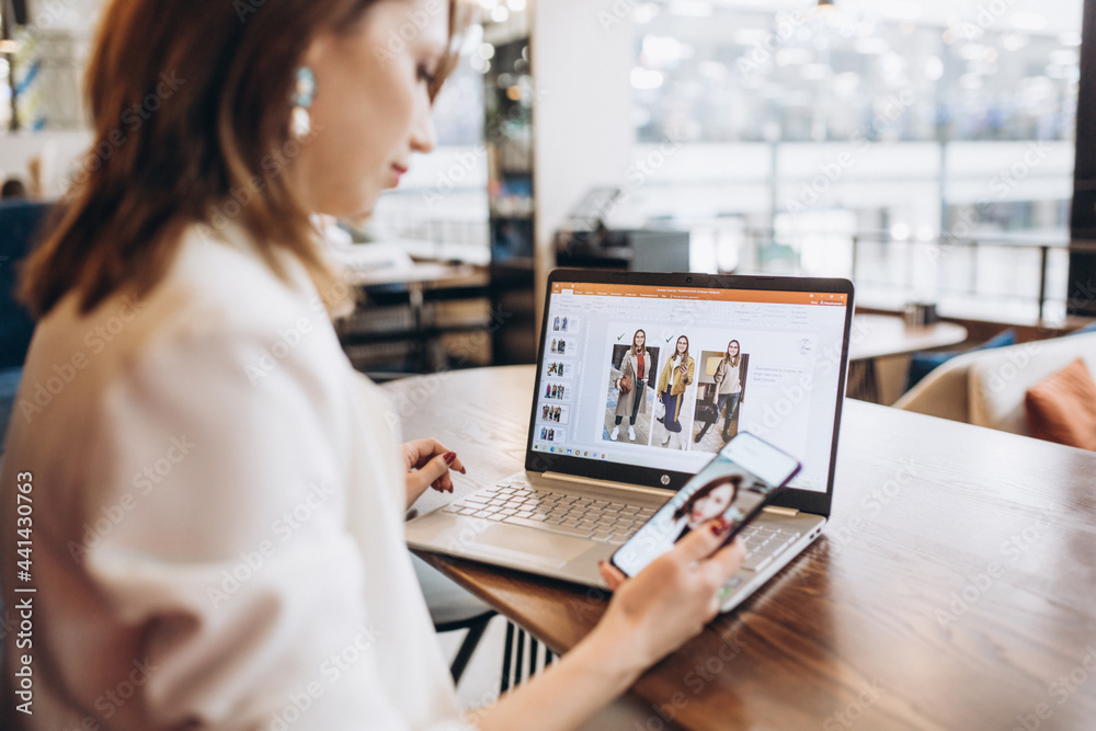 Beautiful Young Freelancer Woman Using Laptop Computer Sitting At Cafe Table. Happy Smiling Girl Working Online Or Studying And Learning While Using Notebook. Freelance Work, Business People Concept Beautiful Young Freelancer Woman Using Laptop Computer Sitting At Cafe Table. Happy Smiling Girl Working Online Or Studying And Learning While Using Notebook. Freelance Work, Business People Concept