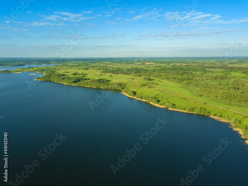 Beautiful aerial landscape on the lake with a drone. Many lake islands covered with forests, fields on a sunny day © yaroslav1986
