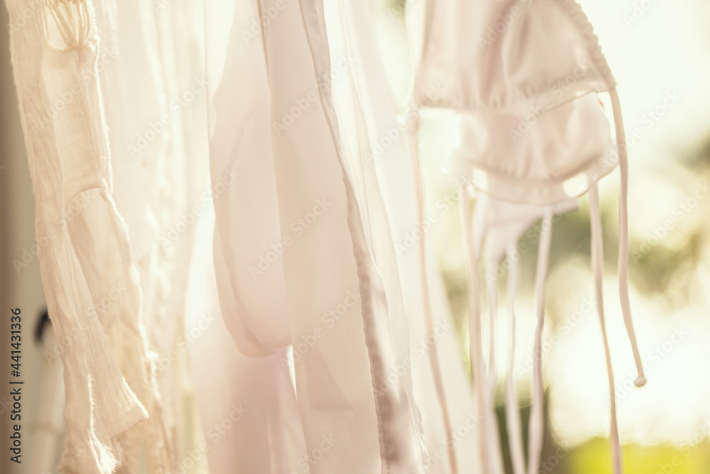 Closeup hanging laundry on balcony on the drying rack at sunset sunshine Closeup hanging laundry on balcony on the drying rack at sunset sunshine
