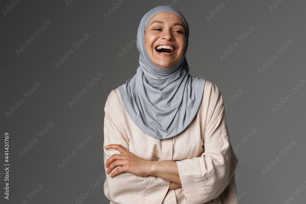 Middle eastern woman in hijab posing and laughing at camera Middle eastern woman in hijab posing and laughing at camera
