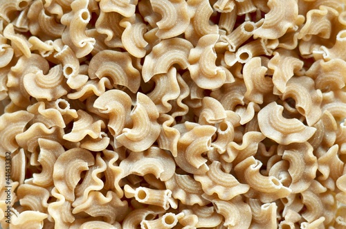 Dry whole wheat macaroni pasta on full frame.