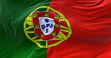 Detail of the national flag of Portugal flying in the wind.