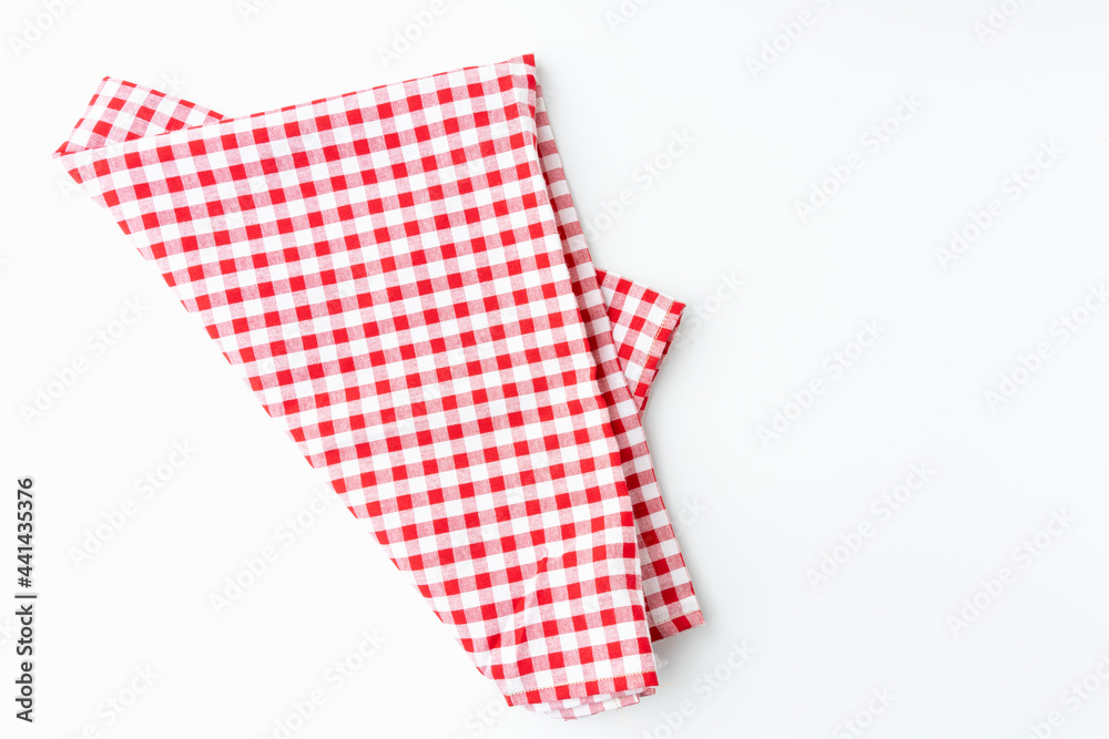 Top view for food menu design. Used to cover the dining table, for easy to clean the table. A crumpled dining tablecloth with a white and red checker isolated pattern is placed on a white background. Top view for food menu design. Used to cover the dining table, for easy to clean the table. A crumpled dining tablecloth with a white and red checker isolated pattern is placed on a white background.