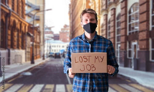 person holding a cardboard with text "lost my job" searching for occupation