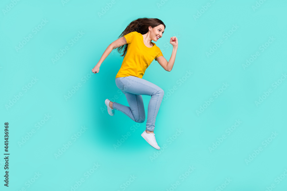 Full body profile photo of funny young lady run wear yellow t-shirt jeans isolated on teal color background