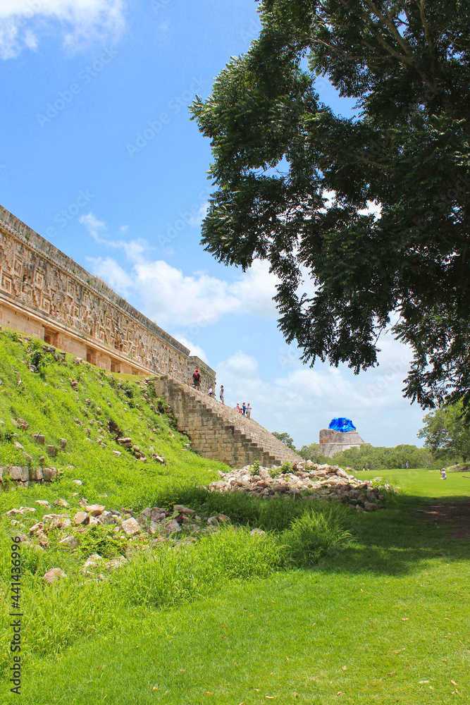 Uxmal, Governor palace and pyramid of the Magician on background, territory of Uxmal archeological and historical site, old city, representative of the Puuc architectural style on the Yucatan, Mexico