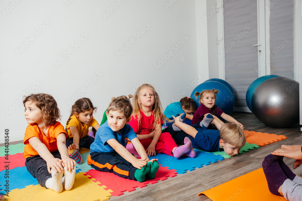 © oksix - Children exercising while physical education lesson at preschool © oksix - Children exercising while physical education lesson at preschool