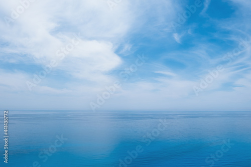 Endless tranquil seascape with cloudy sky.