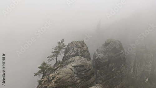 Timelapse. An early cloudy morning in mountain. Schrammsteine - group of rocks are a long, strung-out, very jagged in the Elbe Sandstone Mountains located in Saxon Switzerland in East Germany.