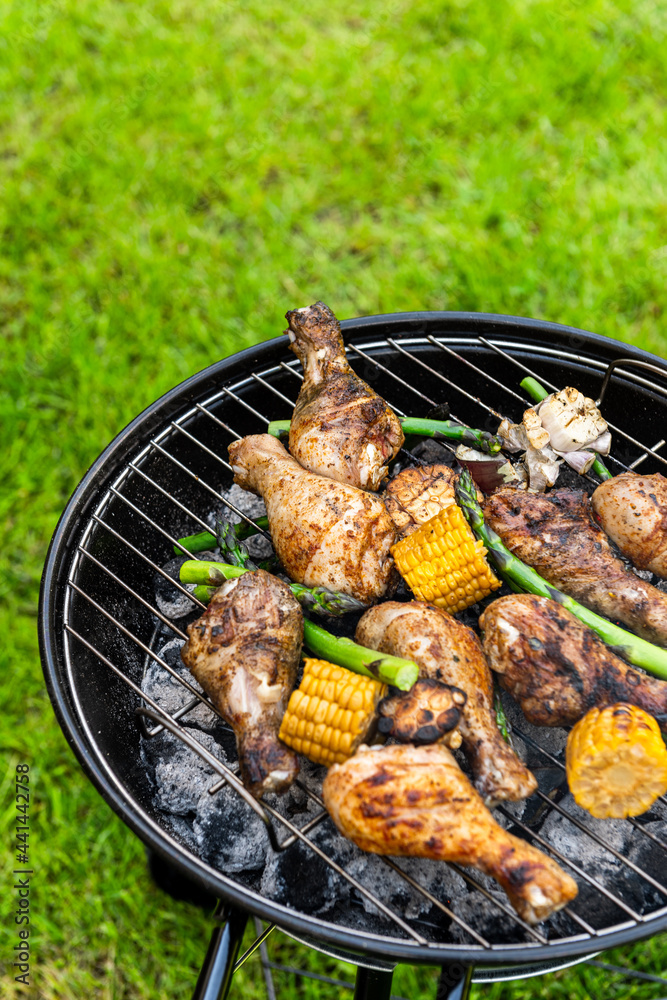 Grilled Food on Charcoal BBQ. Summer Picnic in Backyard Garden Grilled Food on Charcoal BBQ. Summer Picnic in Backyard Garden