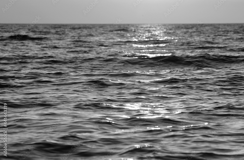 Evening sun over the tropical sea with waves Evening sun over the tropical sea with waves