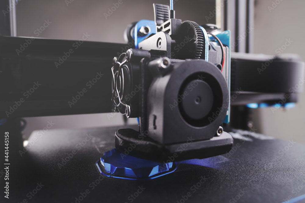 black FDM 3D printer manufactures a hollow part from metallic blue plastic in thick layers - additive manufacturing concept with selective focus - obrazy, fototapety, plakaty 