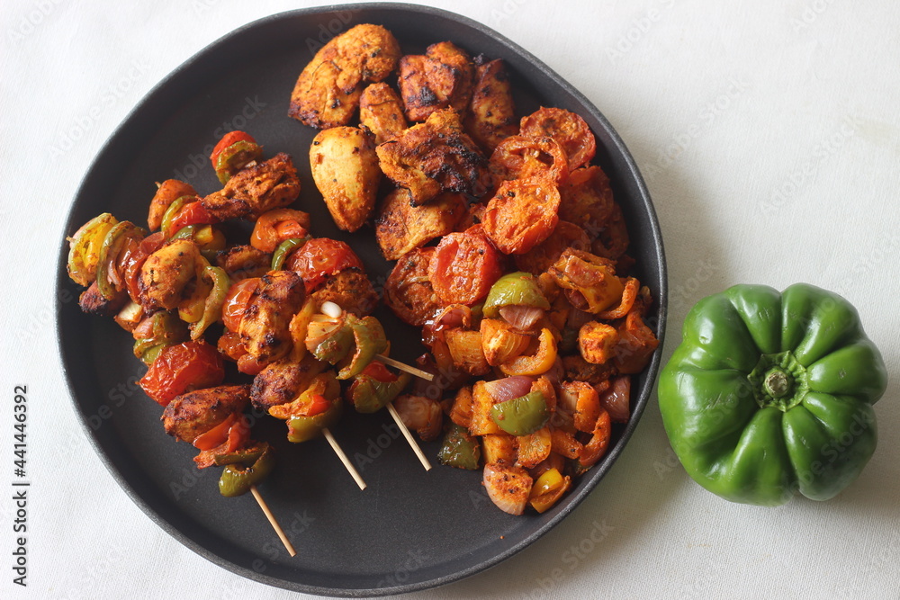 Air fried chicken and bell peppers in skewers. Boneless chicken cubes marinated with yogurt and