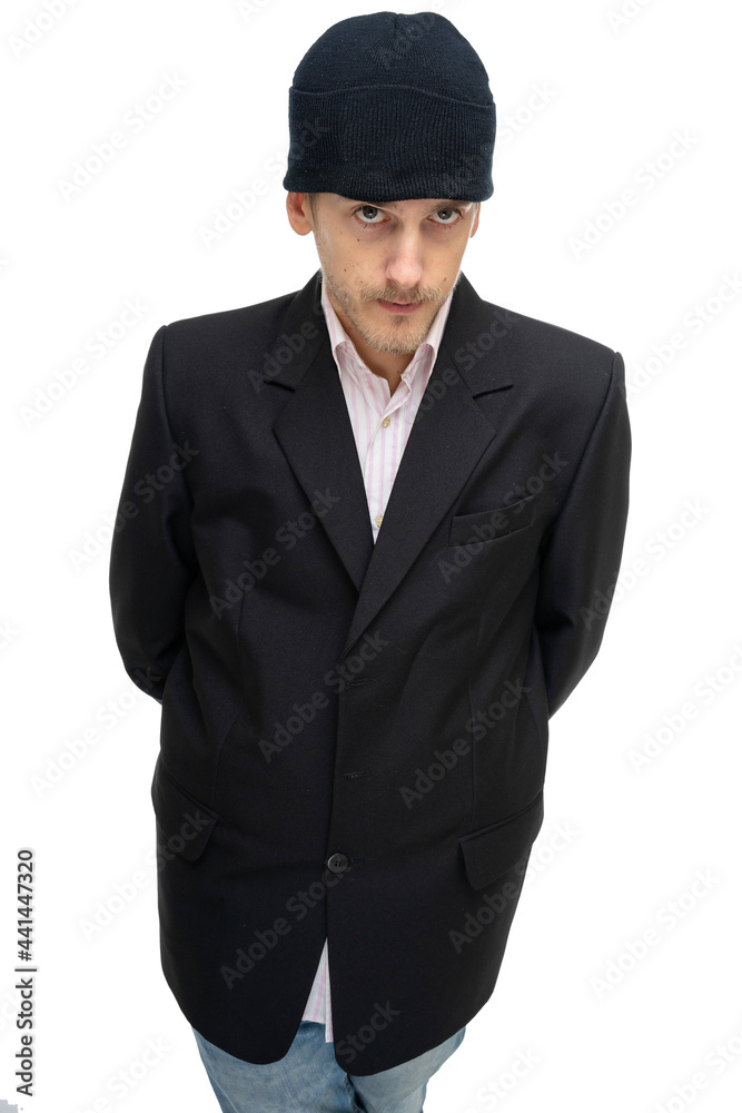 Young handsome tall slim white man with brown hair looks shy in black blazer with black winter hat isolated on white background Young handsome tall slim white man with brown hair looks shy in black blazer with black winter hat isolated on white background