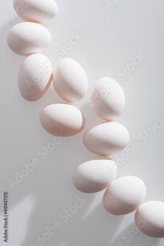 top view of organic eggs in shell on white background
