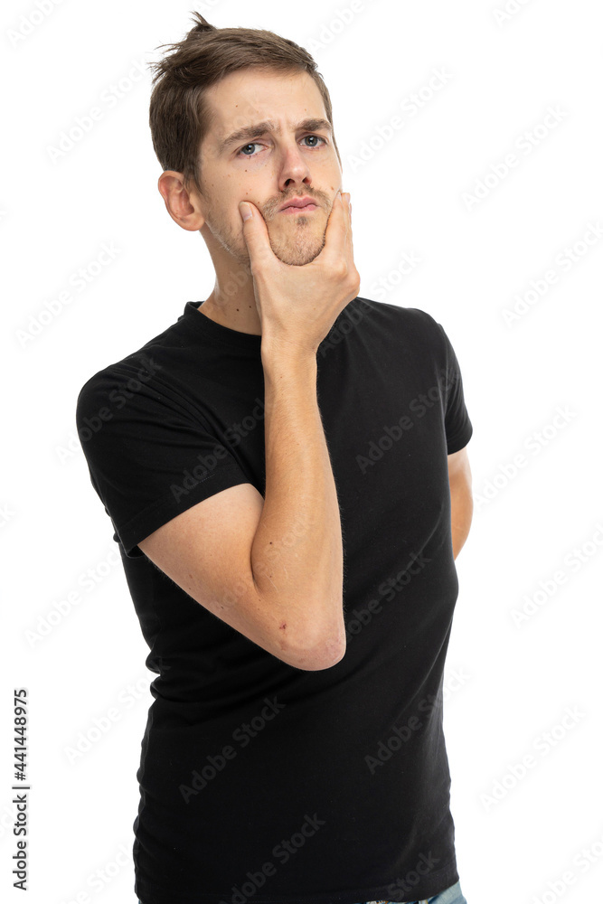 Young handsome tall slim white man with brown hair is making a decision in black shirt isolated on white background Young handsome tall slim white man with brown hair is making a decision in black shirt isolated on white background