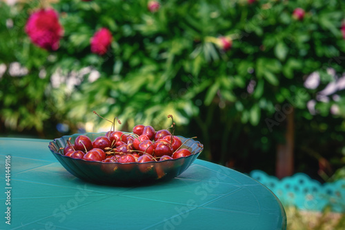 Fresh cherries in a plate on the table. Fresh ripe cherries. photo