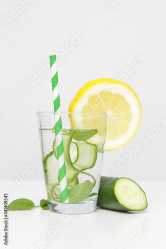 Lemon cucumber water with colorful paper straw. Healthy detox drink.